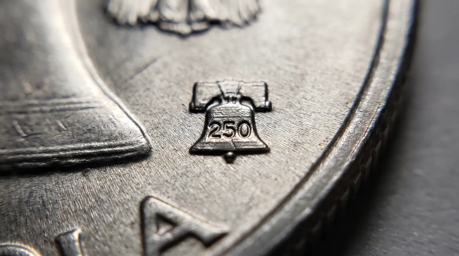 Close-up of the Liberty Bell 250 privy mark on a 2026 anniversary coin