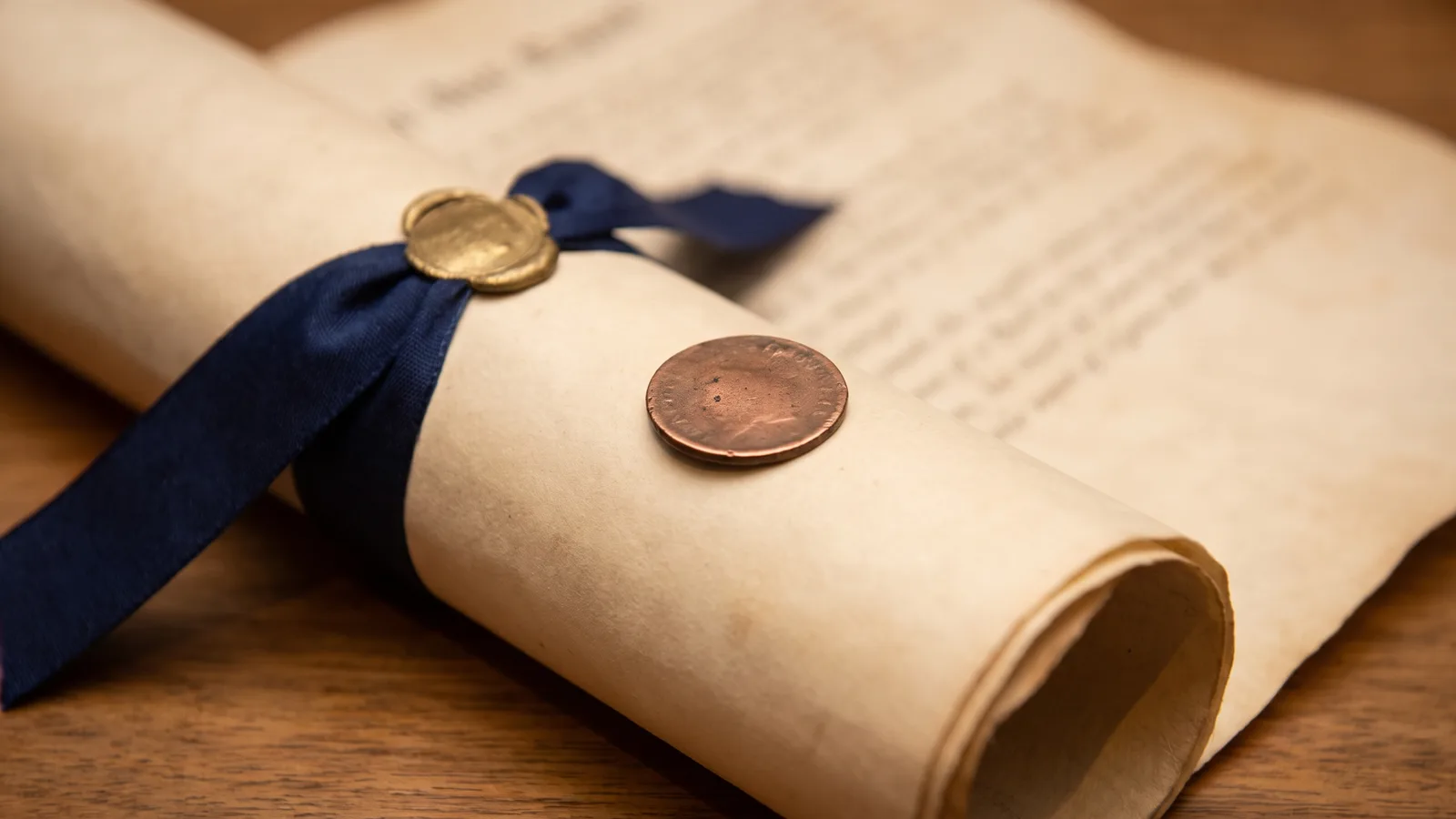 A token resting on a rolled antique legal document