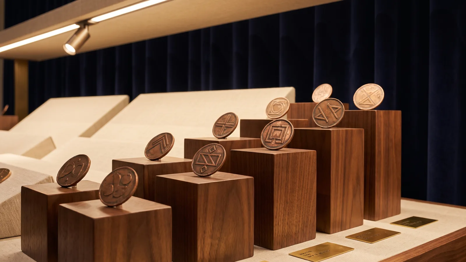 Copper tokens arranged in rising tiers on stepped blocks