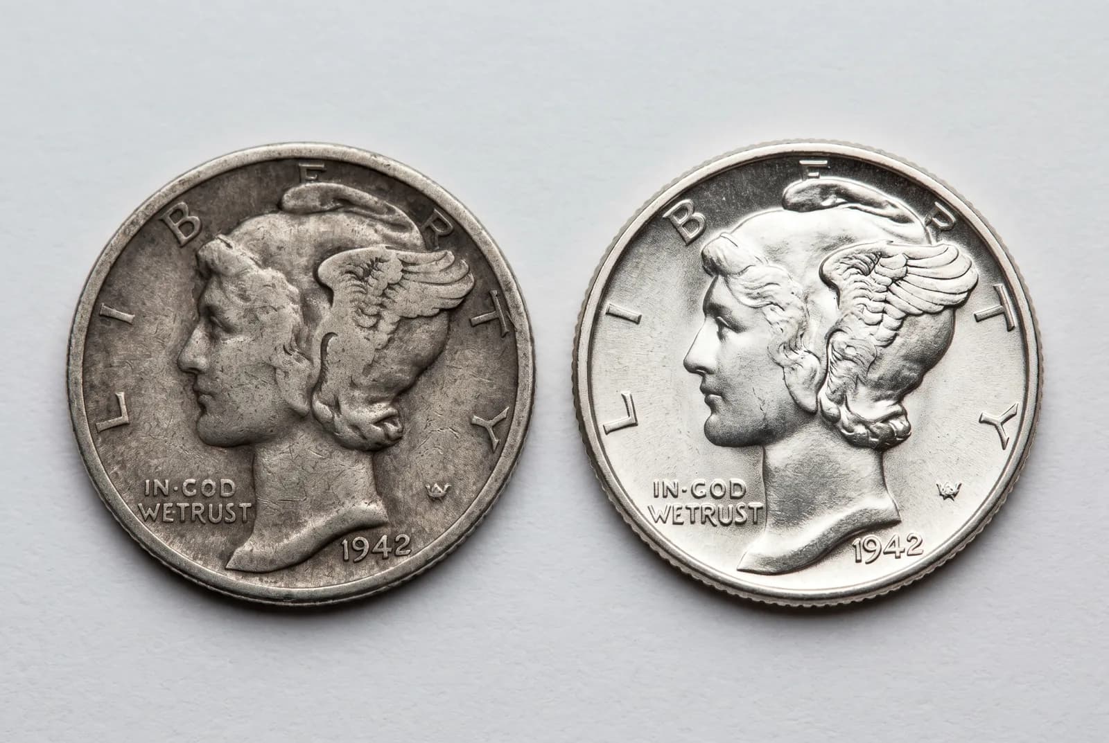 A worn circulated coin beside a lustrous mint-state example of the same type