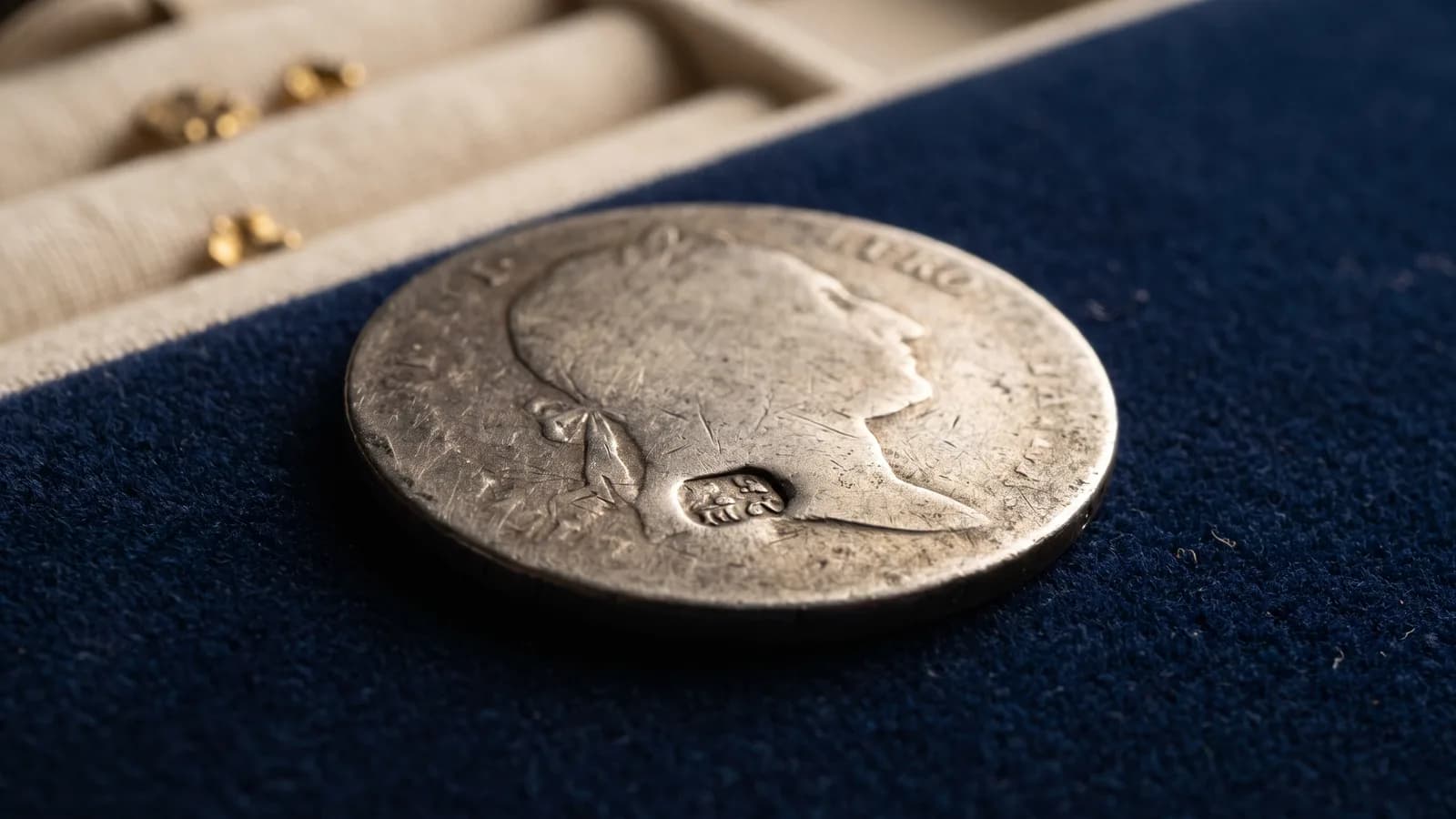 A counterstamped silver coin under raking light