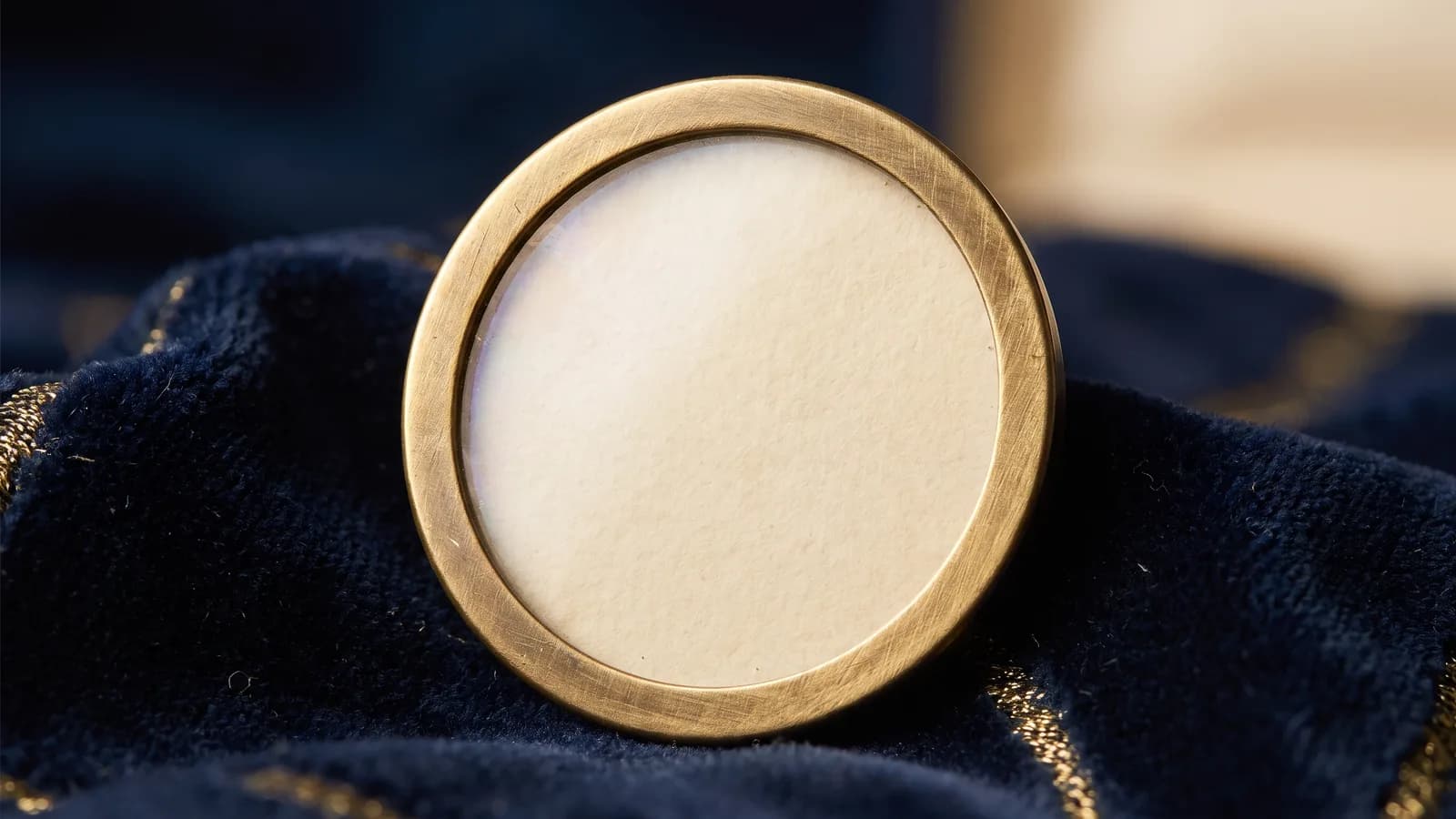 Macro of a brass-rimmed disc with a clear mica window