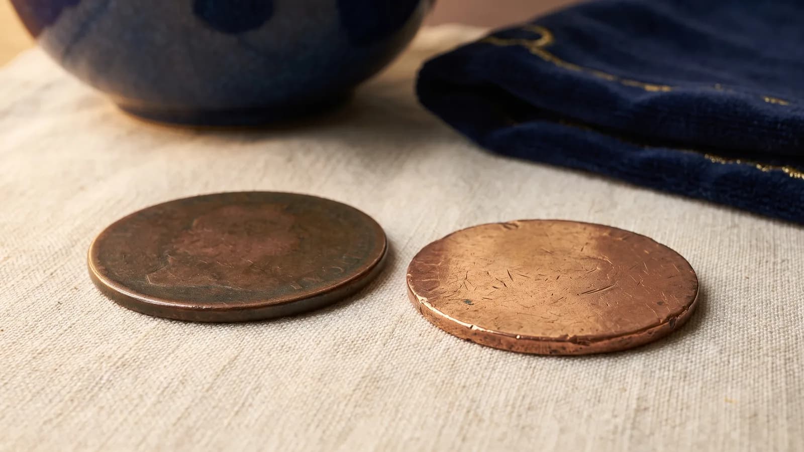 Two large copper coins side by side for comparison