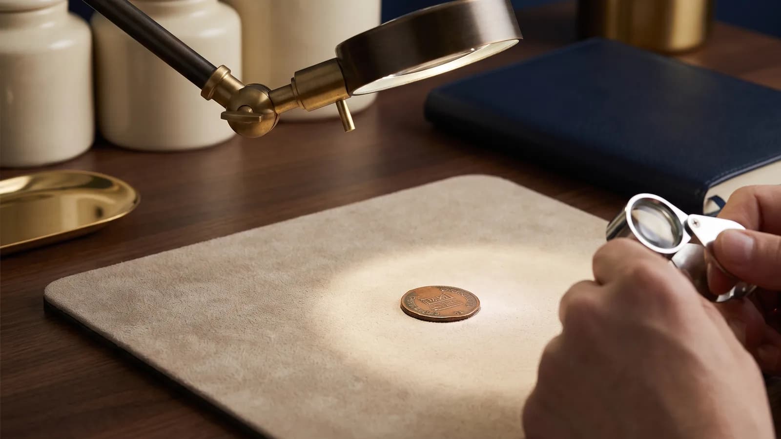 A token under a bright loupe on a grading desk