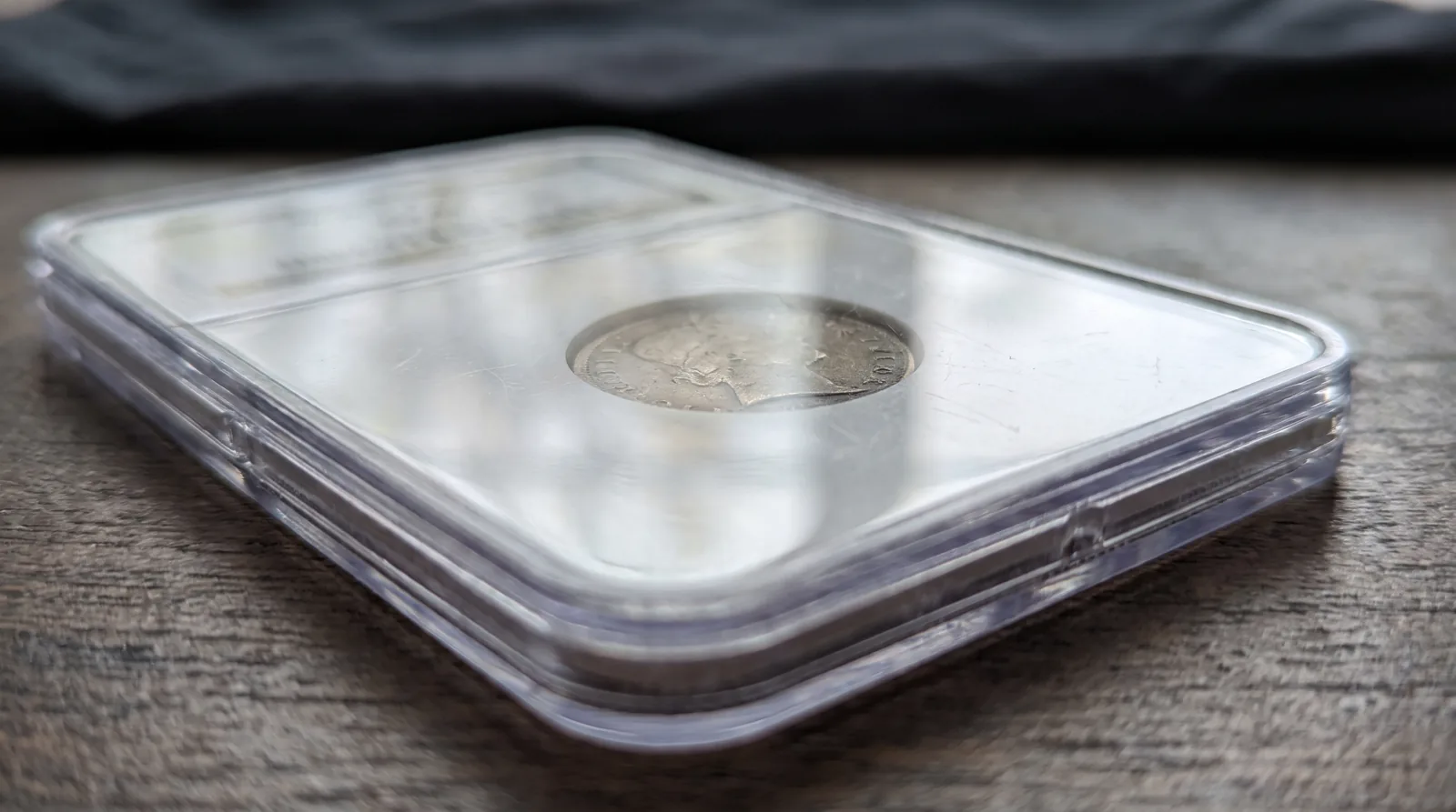 A certified coin sealed in a tamper-evident grading slab