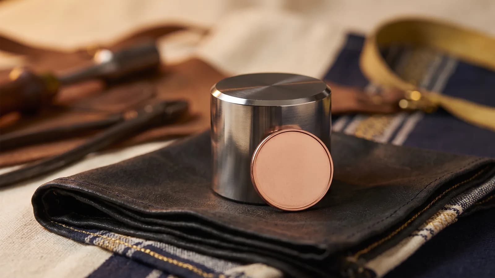 A steel die beside a freshly struck copper piece