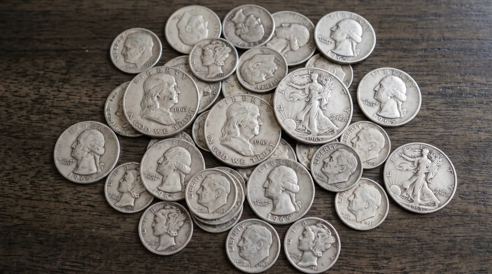 A pile of pre-1965 ninety percent silver U.S. dimes and quarters