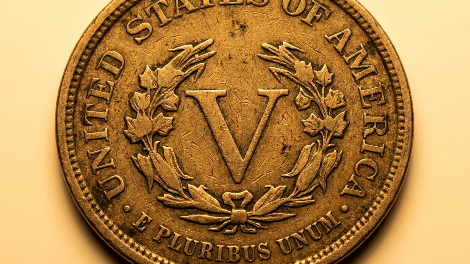 An 1883 Liberty Head nickel reverse showing the large V without the word CENTS