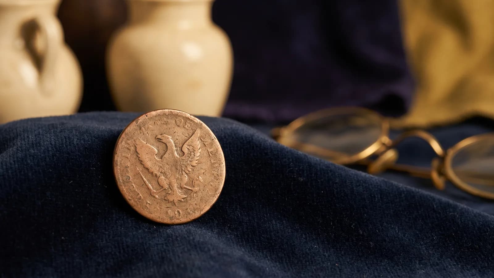 Macro of a faint eagle relief on an aged copper disc