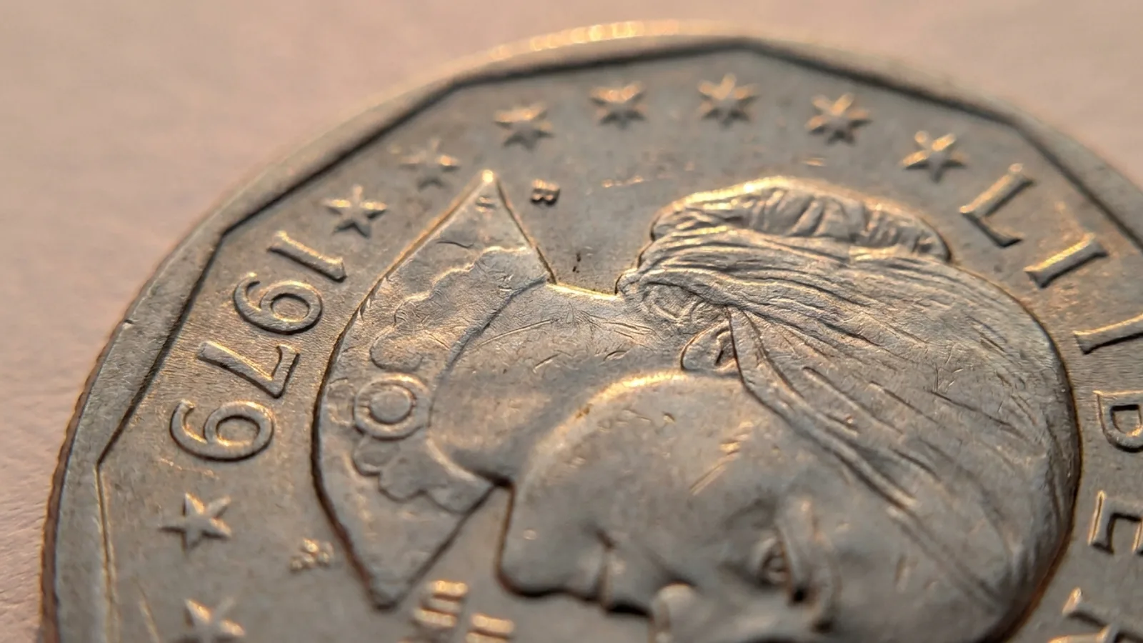 A Susan B. Anthony dollar showing the date close to a wide rim
