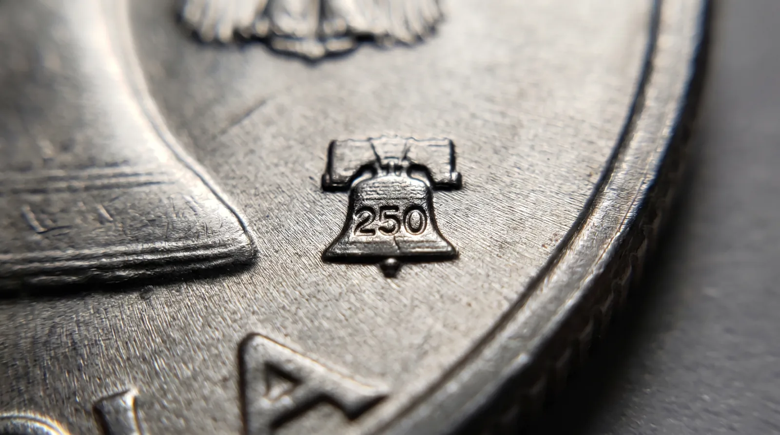 Close-up of the Liberty Bell 250 privy mark on a 2026 anniversary coin